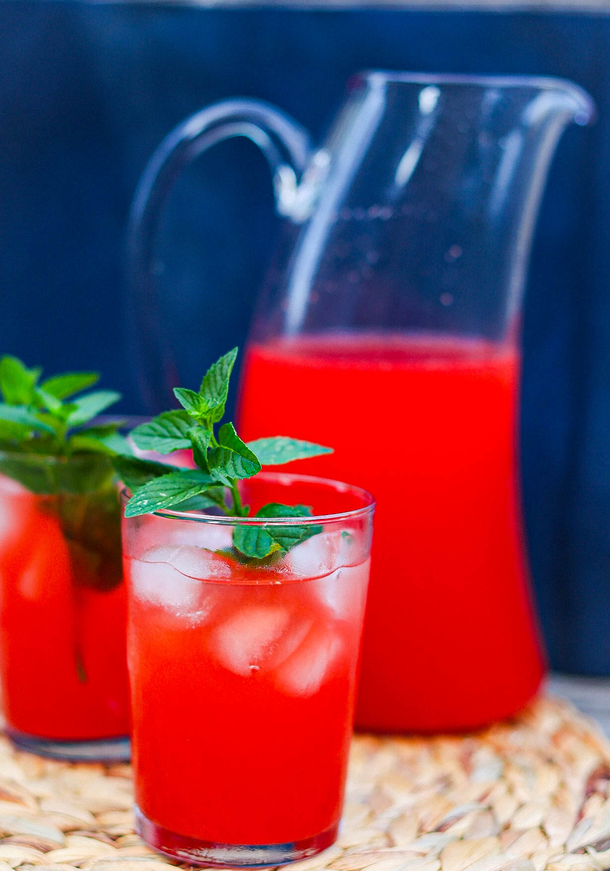 rum punch in two glasses plus a tall pitcher